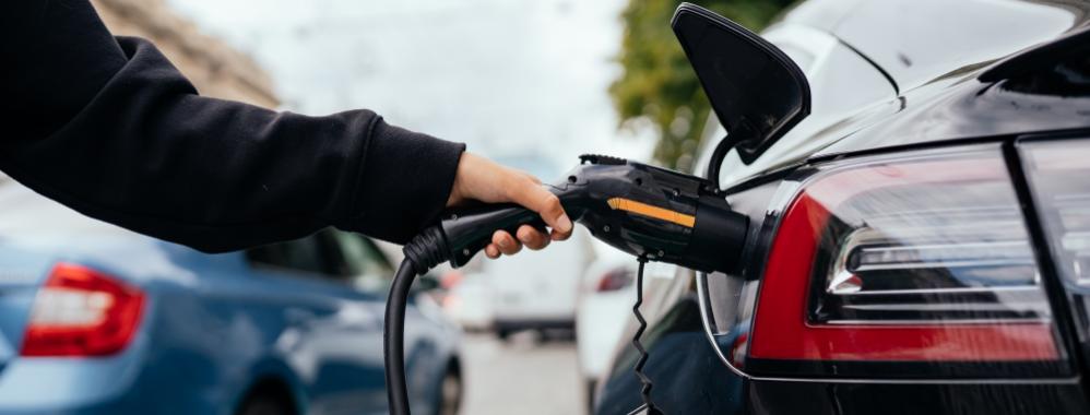 woman-charging-electric-car-charging-station